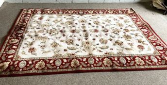 A modern floral carpet, decorated with floral arabesques on a white cream ground and withing wide