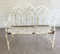 A vintage white painted garden bench; together with three composition stone garden ammonites and two