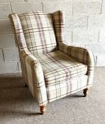 A tartan upholstered armchair, circa 2017, with turned feet