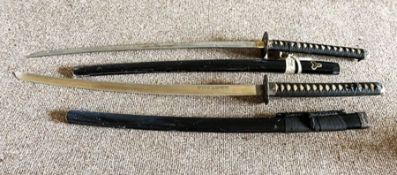 Two Japanese Katana, 20th century decorative swords, with scabbards, one with a signed blade