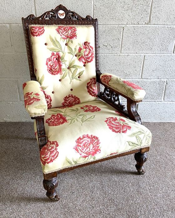 A late Victorian easy chair, with carved back and padded armrests, currently upholstered in floral - Image 2 of 6