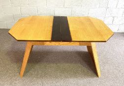 An oak Art Deco style octagonal library table, with octagonal top and splay pier ends, with