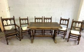 An oak Jacobean dining suite, with a small extending refectory style dining table, with pier