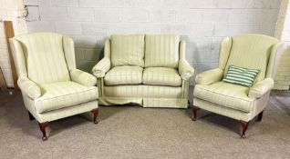 Two modern Wesley-Barrel upholstered armchairs; together with a similar small sofa, currently