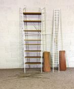 A Ladderax bookcase system, with four white painted stands and assorted adjustable shelves, 214cm