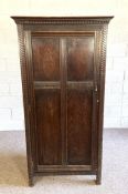 A vintage oak single wardrobe with guilloche carved border