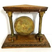 A 19th century oak and gilt brass table gong, with Corinthian column supports and suspended gong,