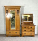 An Arts & Crafts oak single wardrobe and matching dressing chest, early 20th century, the wardrobe