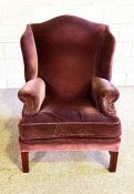 A vintage wing armchair, currently upholstered in purple cloth