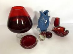 A group of ruby glassware, including a large 'goblet' vase and two ash trays; also a Plymouth Gin