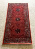 Four assorted small rugs, including a modern Prayer rug with two medallions on a red ground (4)