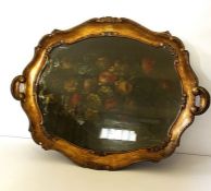 A large 19th century 'tole' painted tea tray, the centre set with a Still Life of Flowers, painted