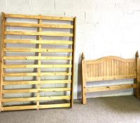 A pine double bed, modern, with arched headboard and finials, 149cm wide