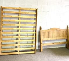 A pine double bed, modern, with arched headboard and finials, 149cm wide