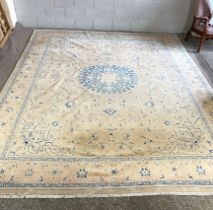 A large modern carpet, with medallion on a cream ground, 450cm long by 340cm wide