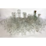 A large assortment of table glassware, including various decanters, wine glasses, tumblers etc. (a