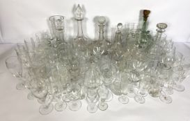 A large assortment of table glassware, including various decanters, wine glasses, tumblers etc. (a