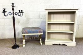 A modern painted three shelf open bookcase, together with a decorative Renaissance style candle