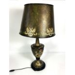 A modern ‘toleware’ style table lamp, with decorative armorial on the urn shaped base, with