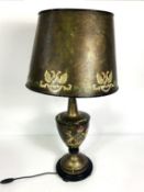 A modern ‘toleware’ style table lamp, with decorative armorial on the urn shaped base, with