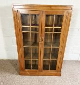 A mid 20th century mahogany glazed bookcase, with two doors, 137cm high; and a pair of Edwardian