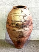 A very large Mediterranean style amphora vase, of tall ovoid form, with striated bands