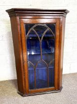 A George III wall hanging corner cabinet, late 18th century, with arch moulded glazed cabinet