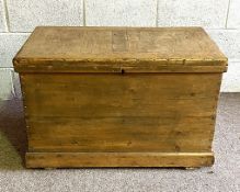 A vintage stripped pine tool or blanket chest, with a hinged and panelled lid, 58cm high, 89cm wide