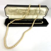 A cased set of simulated pearls, single string, cased; and another similar set (2)