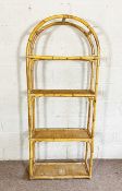 A tall four shelf bamboo stand, 20th century, with arched top and woven bamboo shelves, 185cm high