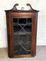 A George III mahogany wall hanging corner cupboards, circa 1780, with swan necked pediment, dentil