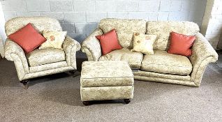 A modern three piece suite, with a large sofa with outscrolled arms and deep seat cushions; a