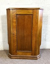 An oak Georgian style corner cabinet, 97cm high, 70cm wide