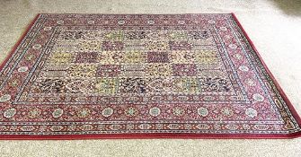 A modern decorative Caucasian style rug, with divided rectangular sectioned field, and red