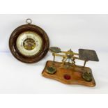 A late Victorian wall mounted aneroid barometer, with 27-31 scale; also a small postage scales,