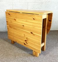 A modern drop leaf dining table, with one rounded leaf and one rectangular leaf, 150cm long