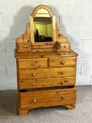 A modern pine dressing chest, with arched mirror; together with a pair of three drawer bedside