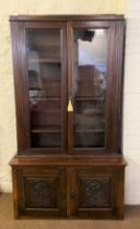 A glazed bookcase, with adjustable shelves, the base with two panelled doors, 146cm high, 112cm