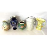 A small group of colourful vases and lamp bases, including a decorative jug with stylized flower