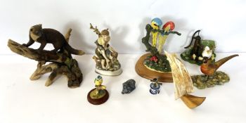 A group of assorted figurines, including a stoat, blue tit and two parrots (a lot)