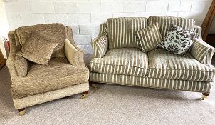 A modern two seat sofa, with striped upholstery, deep seats and brass caps and castors; also similar
