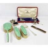 A small group of silver items, including a silver a green enamel backed three brush set; a silver