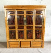 A vintage Chinese side cabinet, early/mid 20th century, with four panelled doors, each segmented