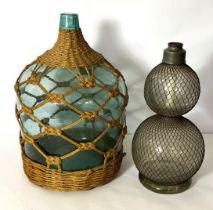 A large green glass demi john bottle with ropework, and a decorative double gourd glass lamp (2)