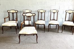 A set of six Edwardian mahogany framed salon chairs, with shaped and padded crests and pierced