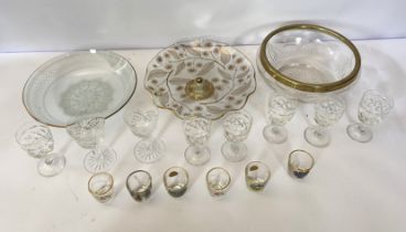 Assorted glassware, including a green glass decanter with stopper, various wine goblets, and gilt