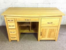 A modern desk, with well rectangular plain top over arrangement of multiple drawers, niches and a