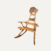 A contemporary rocking chair, with asymmetrical and rustic frame, probably ash wood, with a deep