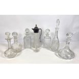 A group of decanters and a silver plated and moulded glass claret jug, including a pair of square