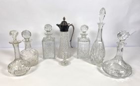 A group of decanters and a silver plated and moulded glass claret jug, including a pair of square